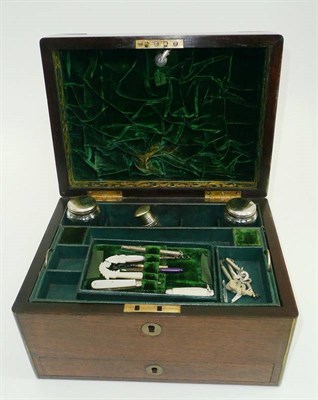 Lot 81 - # A 19th century brass bound rosewood fitted travelling case, with five bottles, two penknives,...