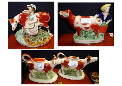 Lot 91 - # A Staffordshire pottery cow and milkmaid group, on an oval base, 20.5cm high, a similar cow...