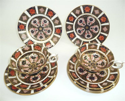 Lot 107 - A pair of Royal Crown Derby Imari pattern teacups and saucers and six side plates