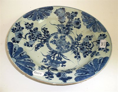 Lot 141 - # A Chinese porcelain dish, Kangxi, painted in underglaze blue with a central foliate roundel...