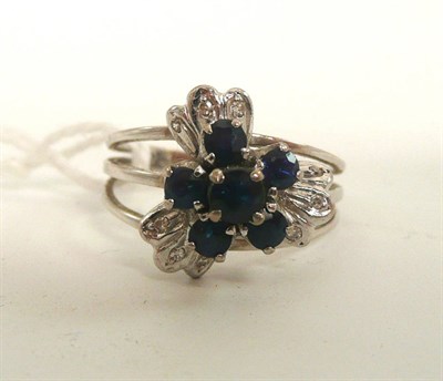 Lot 160 - A fancy sapphire and diamond cluster ring, stamped '585'