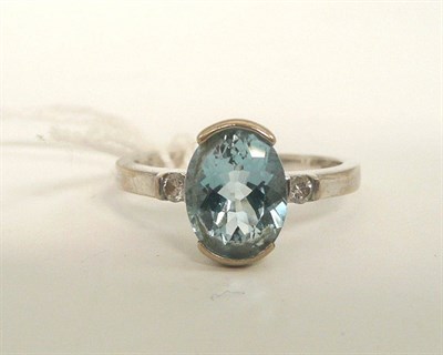 Lot 184 - An aquamarine and diamond three stone ring, stamped '14k'