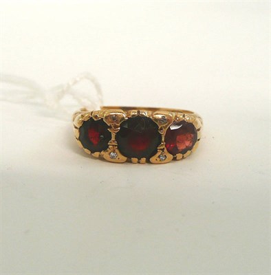 Lot 185 - An 18ct gold garnet and diamond ring (some damage to the stones)