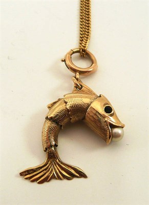 Lot 189 - # A 9ct gold fish pendant, the articulated fish holds a cultured pearl in its mouth, measures 3.4cm