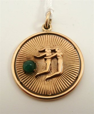 Lot 194 - # A 9ct gold pendant, depicting two figures and set with a cabochon emerald, measures 3.3cm by...