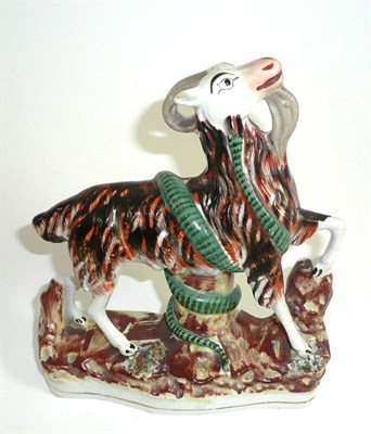 Lot 261 - A Staffordshire model of a goat entwined with a serpent