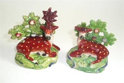 Lot 264 - A pair of Staffordshire models of a doe and a stag with boccage backs