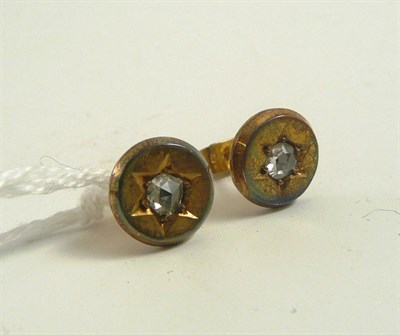 Lot 328 - # A pair of diamond set earrings, of disk form, with a central rose cut diamond within a star...