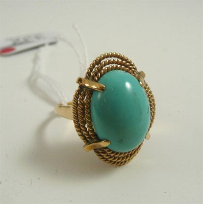 Lot 332 - # A turquoise ring, the oval cabochon turquoise in a triple rope twist frame, finger size V