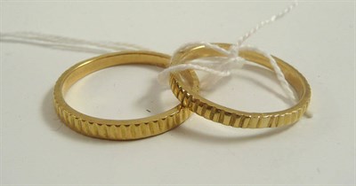 Lot 338 - # An 18ct gold reeded band ring, finger size X½, and a reeded band ring, finger size X