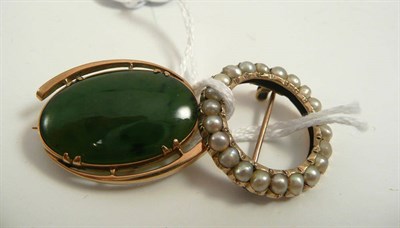 Lot 361 - # A jade brooch, the oval polished jade with a swirl frame, measures 3.2cm by 2.3cm, and a hoop...