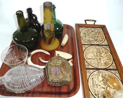 Lot 369 - A set of four pottery tiles (Minton?) within an oak framed tray, green glass bottles, art glass...