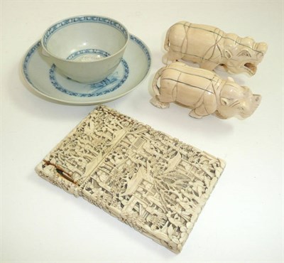 Lot 456 - A large Chinese carved ivory card case, two carved ivory beasts and a Nanking cargo tea bowl...