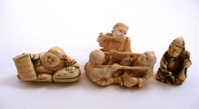 Lot 463 - A good carved ivory okimono of three playful figures, signed and two carved ivory netsukes