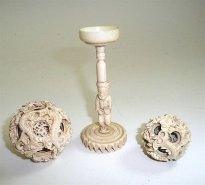 Lot 468 - An early 20th century carved ivory puzzle ball, another smaller and a carved ivory puzzle ball...