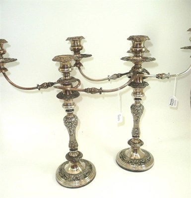 Lot 496 - # Pair of silver plated two branch candelabra