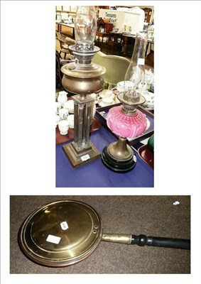 Lot 509 - A cluster column brass oil lamp, another with pink reservoir and a warming pan