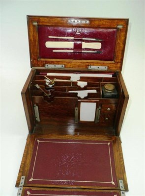 Lot 514 - # A good Edwardian oak desk compendium with fitted interior and fold-out writing slope