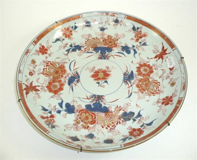 Lot 526 - # A Chinese Imari dish, 18th century, painted with a central flower within radiating foliage...