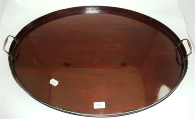 Lot 543 - An oval twin handled mahogany tray