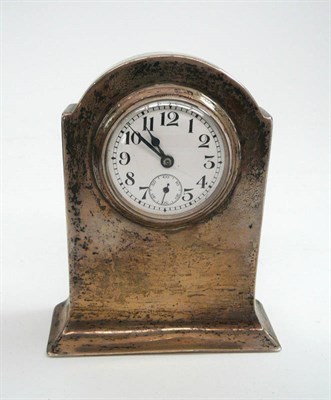 Lot 568 - A small silver mounted dressing table clock