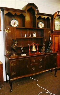 Lot 642 - A 20th century oak dresser with shaped rack