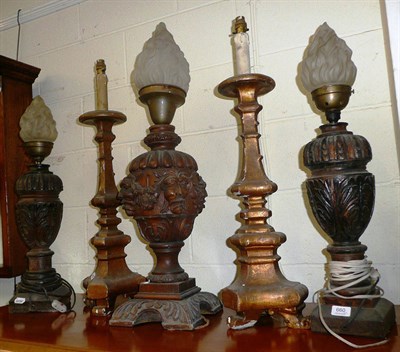 Lot 660 - Carved oak table lamp, a pair of carved oak lamps and a pair of gilt candlesticks