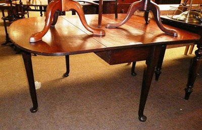 Lot 674 - A Georgian mahogany drop leaf table with paw feet