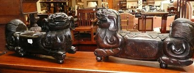 Lot 684 - A pair of late 19th century/early 20th century Chinese carved hardwood dogs