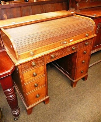 Lot 692 - Oak desk with tambour top and blind fret carving