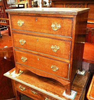 Lot 702 - # A diminutive oak three drawer straight fronted chest on bracket feet