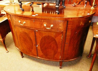 Lot 704 - A reproduction bow fronted sideboard