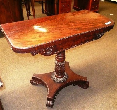 Lot 713 - A carved mahogany fold-over card table (warped top)