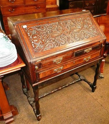 Lot 717 - A small carved oak desk