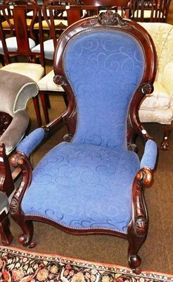 Lot 720 - A Victorian carved walnut blue upholstered nursing chair