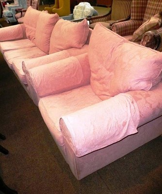 Lot 728 - A pink upholstered sofa, armchair and footstool