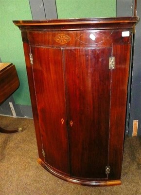 Lot 797 - # George III mahogany hanging corner cupboard barber pull stringing painted interior