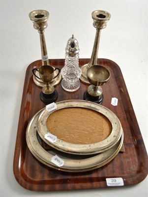 Lot 39 - Pair of loaded silver candlesticks, two graduated oval photograph frames and two small trophy cups