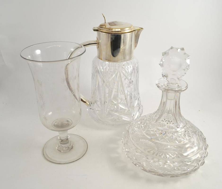 Lot 41 - A heavy cut glass lemonade jug with plated mounts, a cut glass ships decanter and a Georgian celery
