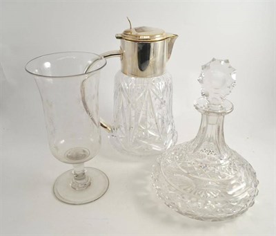 Lot 41 - A heavy cut glass lemonade jug with plated mounts, a cut glass ships decanter and a Georgian celery