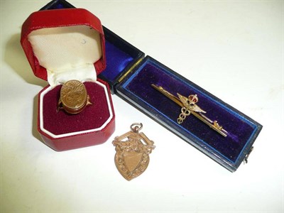 Lot 52 - A military bar brooch, a 9ct gold locket ring and a 9ct gold shield pendant