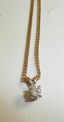 Lot 56 - A diamond solitaire pendant on a 9ct gold curb necklace