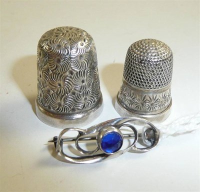 Lot 59 - A silver thimble by Charles Horner 1915, another silver thimble and a brooch set with a blue...