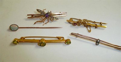 Lot 64 - A peridot bar brooch, an Edwardian seed pearl set brooch, an amethyst and seed pearl set bug...