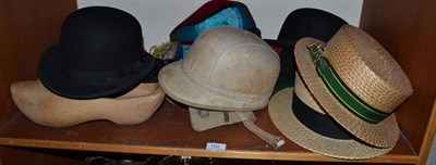 Lot 102 - A collection of hats including two straw boaters, a fez, two bowler hats, etc