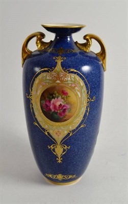 Lot 115 - A Royal Worcester blue ground twin handled vase with floral painted cartouche