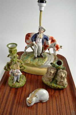 Lot 134 - A Staffordshire spill vase, a Staffordshire cow and boy group converted to a lamp and two other...