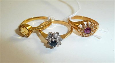 Lot 202 - A ruby and diamond cluster ring, a sapphire ring and a citrine ring (3)