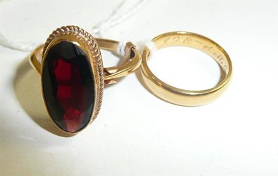 Lot 264 - An 18ct gold band ring and a garnet ring