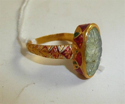 Lot 270 - A floral carved ring in enamelled mount (a.f.)